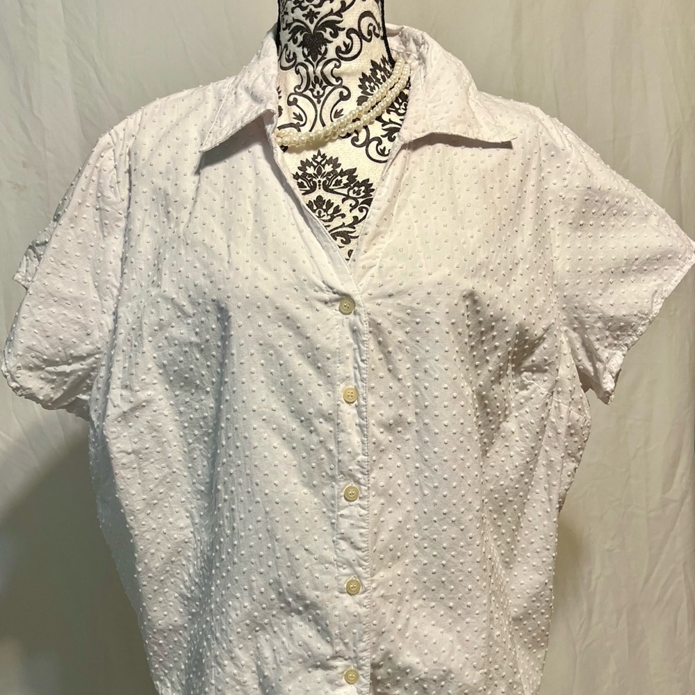 Notations woman, white button down.